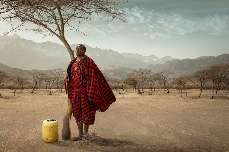 Man standing under a tree in the Tanzanian desert