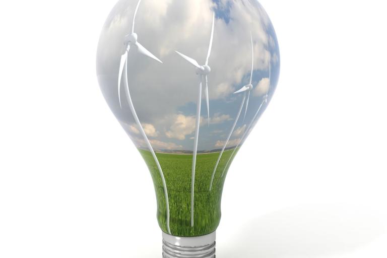 A light bulb with wind turbines in it.