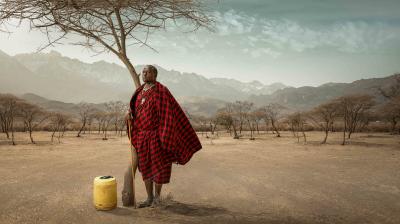 Man standing under a tree in the Tanzanian desert