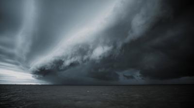 Approaching storm over the ocean with dramatic shelf cloud formation.