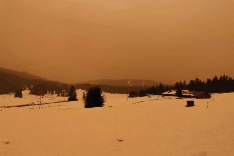 Sand storm is seen over a snowy field in the Jura mountains